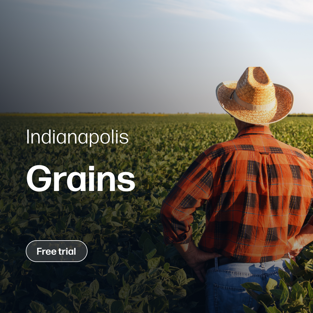 Farmer wearing a straw hat and plaid shirt stands with hands on hips overlooking a vast green grain field under a clear sky, with overlay text about Indianapolis grains and a free trial button.