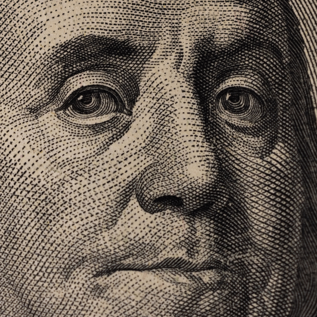 Extreme close-up of a detailed engraving of a historic figure’s face on United States currency, symbolizing financial market insights and exclusive trends analysis.
