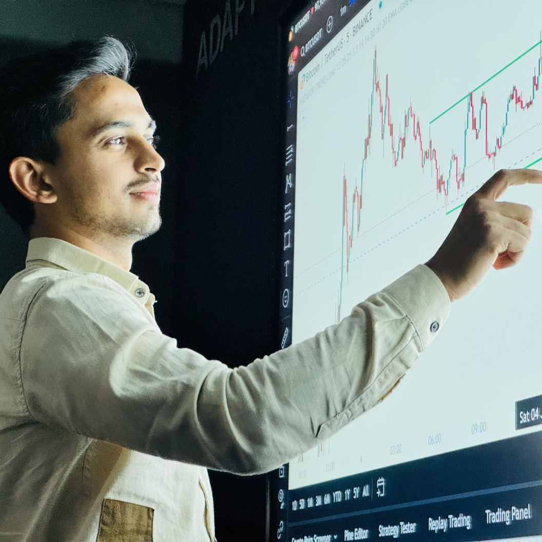 Young professional analyzing stock market data on a large interactive screen, illustrating expert insights and exclusive market analysis for tactical strategies and report subscriptions.
